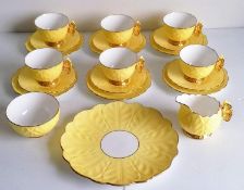 An Art Deco Aynsley lemon yellow butterfly-handle tea set comprising six teacups, saucers, side