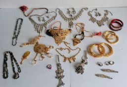 An assortment of Indian silver and silver-gilt bridal jewellery to include three pairs of bangles,