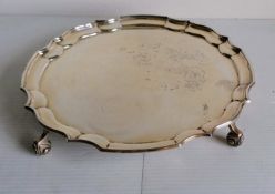 A Georgian-style silver salver with pie crust decoration on four leaf scroll feet by Sanders &