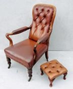 A George IV walnut-framed library or club chair with later footstool, leather button-back