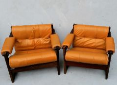 A pair of Percival Lafer lounge chairs with hardwood frames and leather upholstery, labelled Lafer