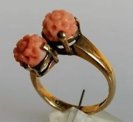 A mid-century carved coral crossover ring on a 9ct yellow gold shank, size N, hallmarked 4.14g