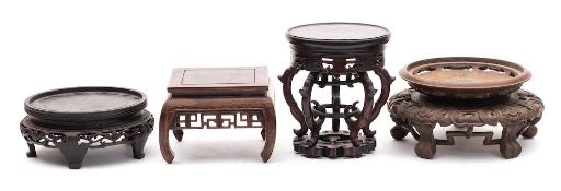 A group of four large Chinese carved hardwood and other stands: 18-26cm wide [4].