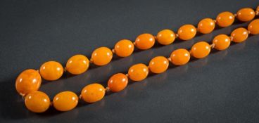 A graduated amber bead single-string necklace: composed of forty-six oblong beads graduated from 13.