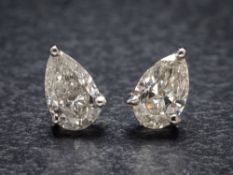 A pair of hallmarked 18ct white gold and pear-shaped diamond single-stone ear studs: each diamond