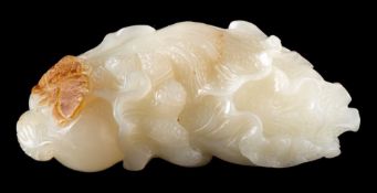 A Chinese pale celedon and russet jade carving of baicai: 8.5cm long.