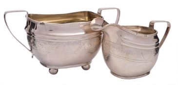 A Sheffield plate cream jug: of barge-shaped outline, with banded scroll and foliate decoration, 15.