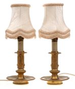 A pair of 19th Century gilt metal table lamps: with fluted and wreath decorated columns,