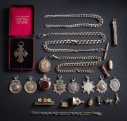 A silver graduated curb-link watch chain, a similar smaller watch chain, seven silver medallions,
