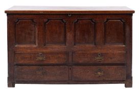 An 18th Century oak rectangular mule chest:, with a plain hinged top,