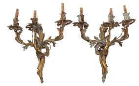 A pair of 19th Century French gilt brass three branch wall lights: with foliate -shaped nozzles,