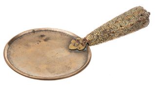 A 19th century Tibetan bronze ceremonial ladle: the shallow circular bowl with inscription to