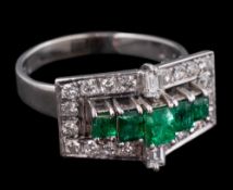 A platinum, emerald and diamond rectangular cluster ring in the Art Deco style.