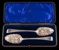 A pair of George III silver and later decorated Old English pattern berry spoons,