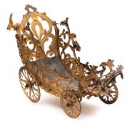A 19th Century pressed metal and gilt decorated metal four wheeled carriage: the pierced foliate