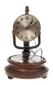 An early Bulle electric clock: the movement connected to a battery set within the base,