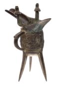 A Chinese bronze tripod wine vessel, Jue: with long spout,