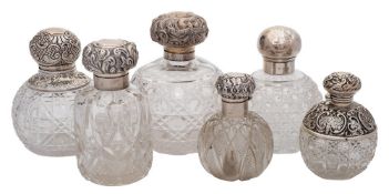 Six various clear cut glass and silver mounted scent bottles: various makers and dates,