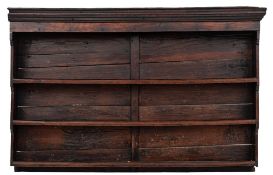 An 18th Century oak dresser:, the associated shelved superstructure with a moulded cornice,