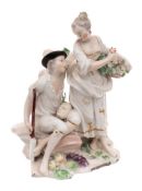 A Derby figural group of 'Gardeners': the seated man with a mask resting on his knee,