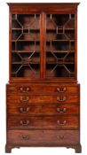 A George III mahogany secretaire bookcase:, the upper part with a moulded dentil cornice,
