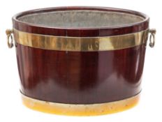 A George III mahogany and brass bound oval wine cooler: of coopered construction with zinc liner