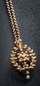 A seed pearl mounted oval pendant/brooch of pierced wreath design: suspending a pearl two-stone
