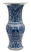 A Chinese blue and white beaker vase: of Gu form painted with shou symbols on a scrolling peony