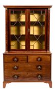 A 19th Century French mahogany bookcase:, the upper part with an overhanging moulded cornice,