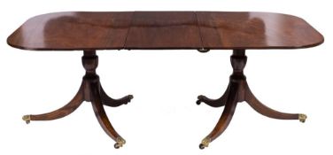 A mahogany twin pillar dining table in the Regency taste:,