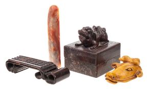 A carved hardstone head of an oxen: 8cm long on a wooden scrolled base,