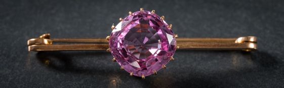 A pink topaz single-stone bar brooch: the cushion-shaped pink topaz approximately 12mm long x 12mm