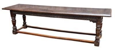 An oak refectory table:, the well patinated single plank top on turned legs,