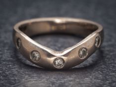 An 18ct white gold and diamond five-stone band: approximately 3.5gms gross weight, ring size L.