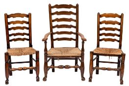 A harlequin set of eight early 19th Century oak, elm and ash ladder back dining chairs:,