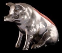 A large novelty metal pin cushion: modelled in the form of a seated pig, 11cm high.
