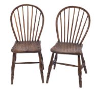 Two early 19th Century 'Yealmpton' ash stick back kitchen chairs:, having shaped solid seats,