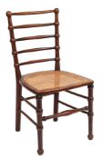 An Arts & Crafts mahogany side chair: with bobbin-turned five-bar back and cane seat,