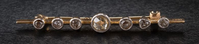 A rose diamond mounted bar brooch: with seven graduated stones to include a heart-shaped rose