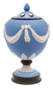 A 'Wedgwood' blue and white jasperware urn and pierced cover: with relief ribbon-tied drapery swag,
