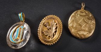 A 19th Century gold oval locket: with engraved strapwork decoration,