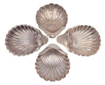 Four assorted silver butter dishes, various makers and dates: of shell-shaped outline,