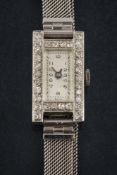 A lady's diamond mounted cocktail wristwatch: the rectangular dial with Arabic numerals and blued