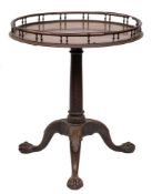 A mid 18th century mahogany circular silver table: with a baluster turned galleried top,