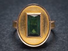 A green tourmaline mounted single-stone dress ring: with central rectangular green tourmaline,