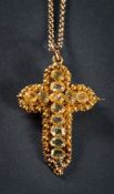 A Cannetille gold and chrysolite pendant cross: approximately 42mm long, with attached gold chain.