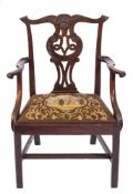 A George III carved mahogany elbow chair:, in the Chippendale taste,