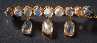A moonstone mounted bar brooch: set with a single row of circular moonstones,