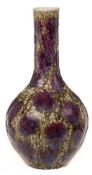 A Chinese green and flambe glazed bottle vase: decorated overall with lavender splashes on a