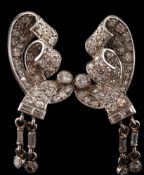 A pair of Art Deco diamond ear clips: each with an open work scroll design mille-grain-set with